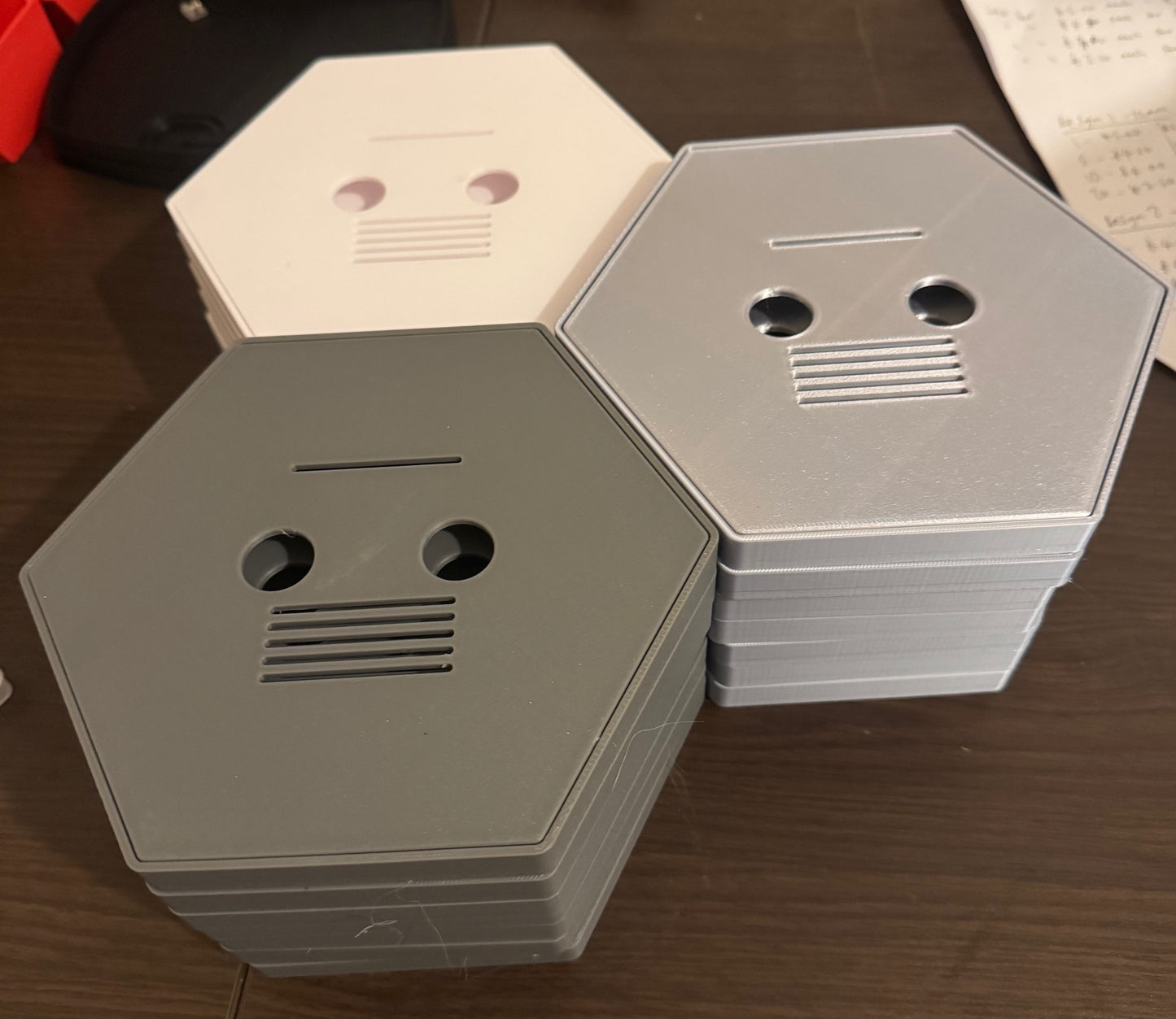 Hexagonal metal boxes stacked on a wooden surface