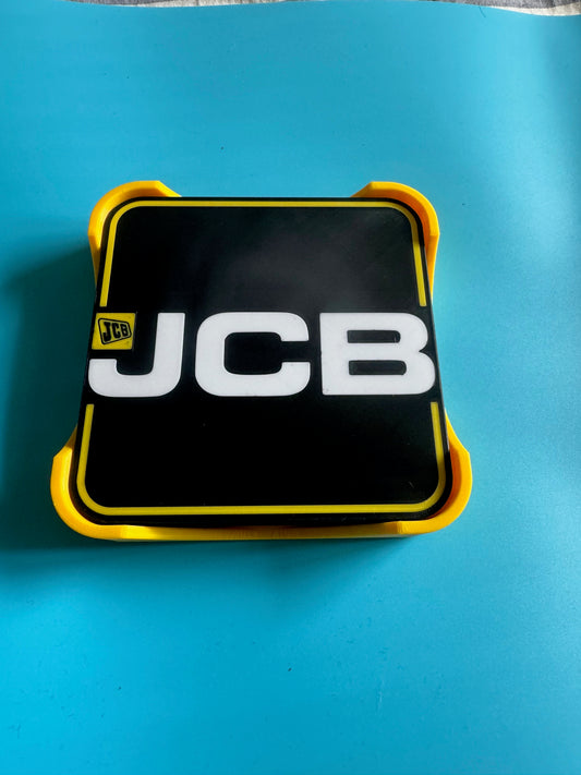 JCB logo on a black and yellow rectangular object against a blue background