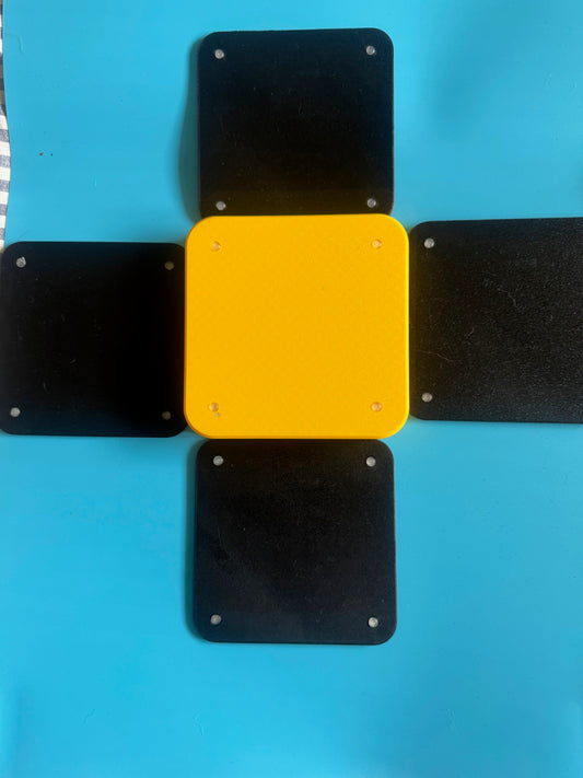 Yellow square with black square attachments on a blue background